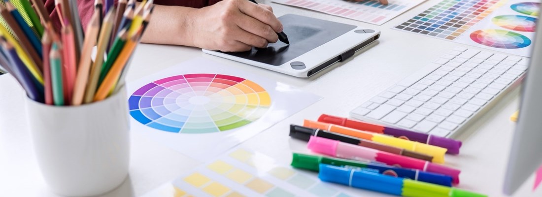 Colour wheels on a table with a person looking through them.