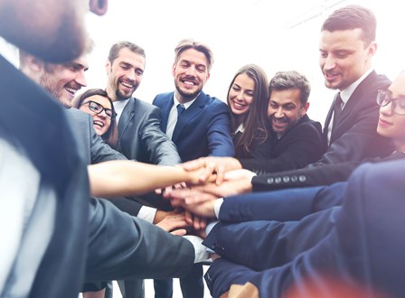 Group of people sat in a room watching a man present stood up