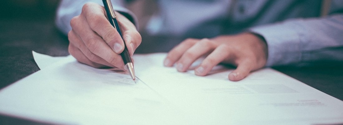 Man writing on a piece of paper