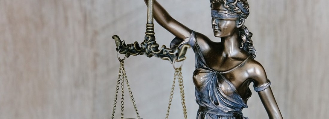 Blind Justice holding scales.