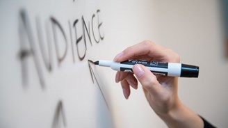 The word 'audience' written on a white board.