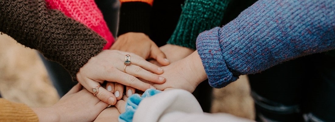 People putting their hands together.