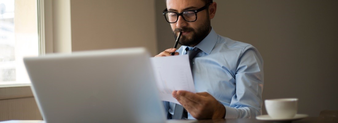 Man looking at a piece of paper.