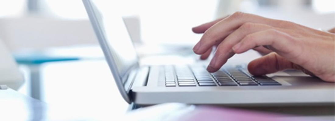 laptop with hands typing